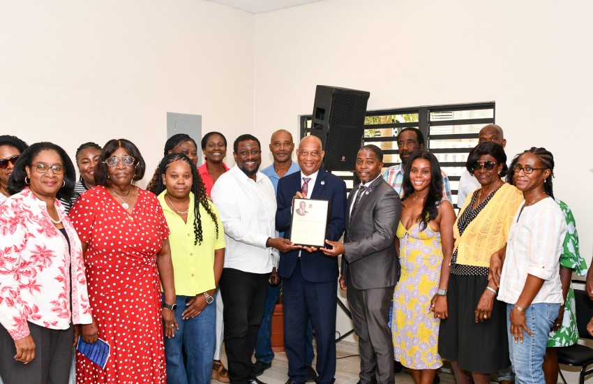 Minister for Health and Social Development Hands Over Memorial Plaque to the Family of George W. Christopher