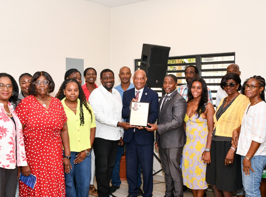 Minister for Health and Social Development Hands Over Memorial Plaque to the Family of George W. Christopher